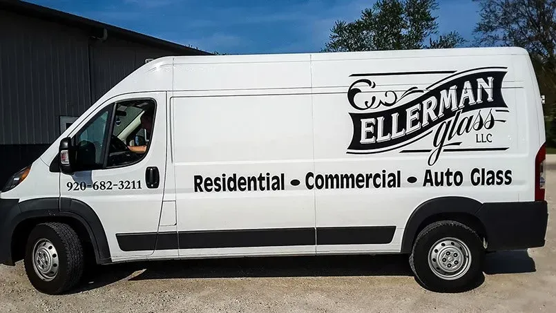 A white van with the words g.b. ellerman glass written on it
