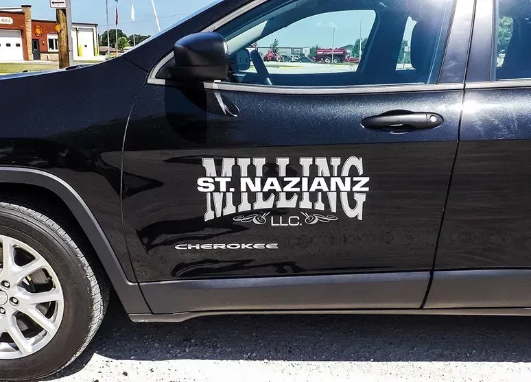A black jeep with the word milling on the side