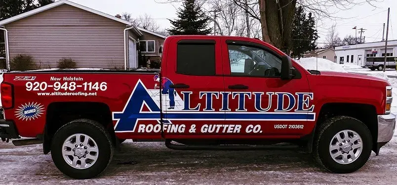 A red truck from altitude roofing and gutter co.