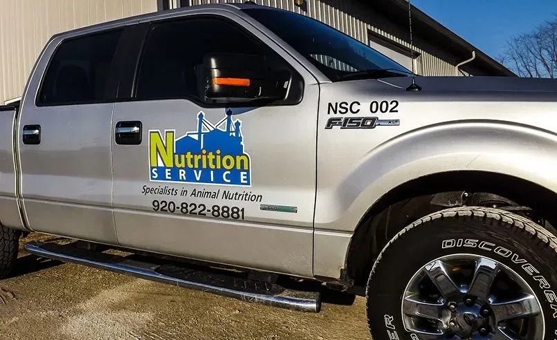 A silver truck with the word nutrition service on the side