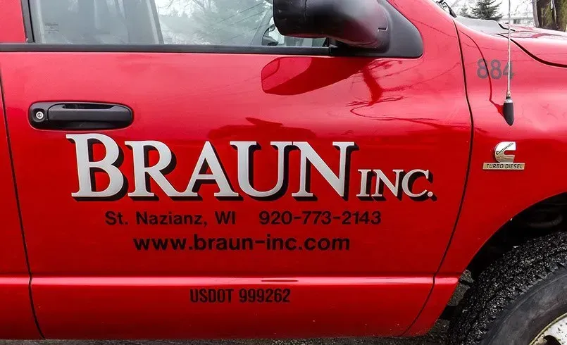 A red truck with braun inc written on the side