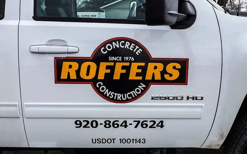 A white truck with a sticker on the side that says roffers construction