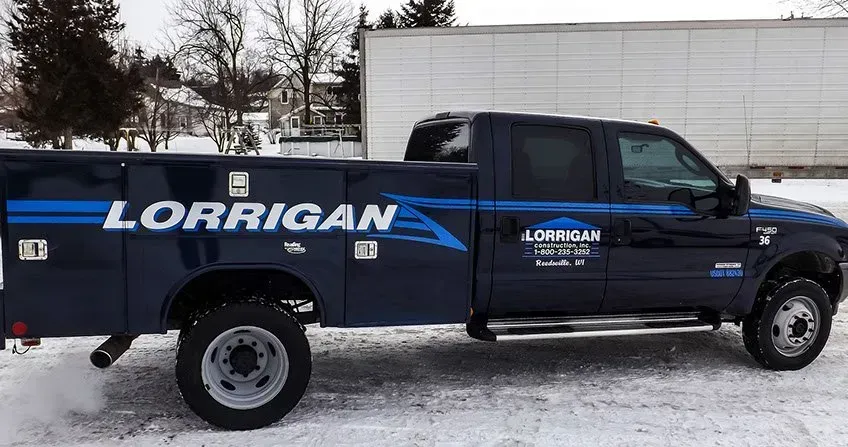 A lorrigan truck is parked in the snow.