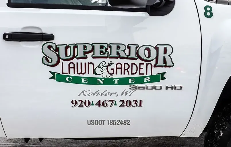 A white truck with superior lawn and garden written on the side