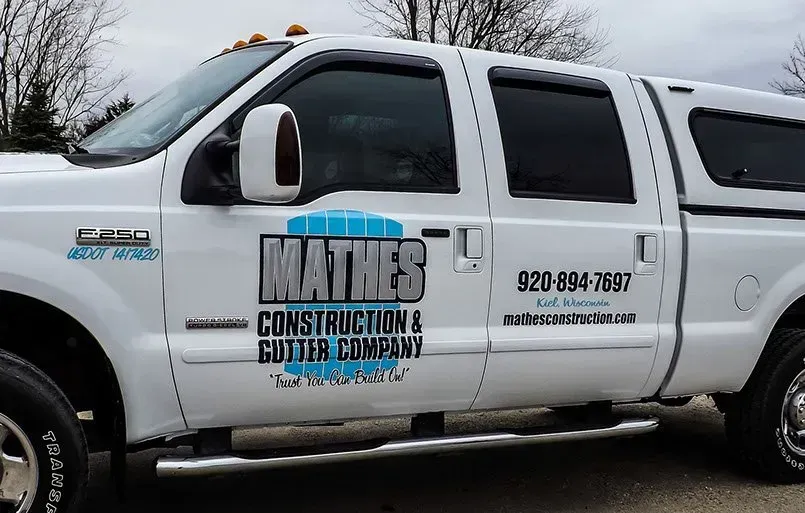 A white truck with the word mathes on the side