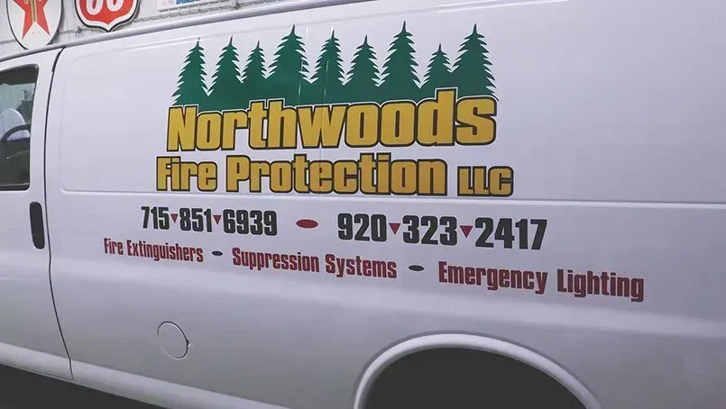 A white van with the words northwoods fire protection written on it