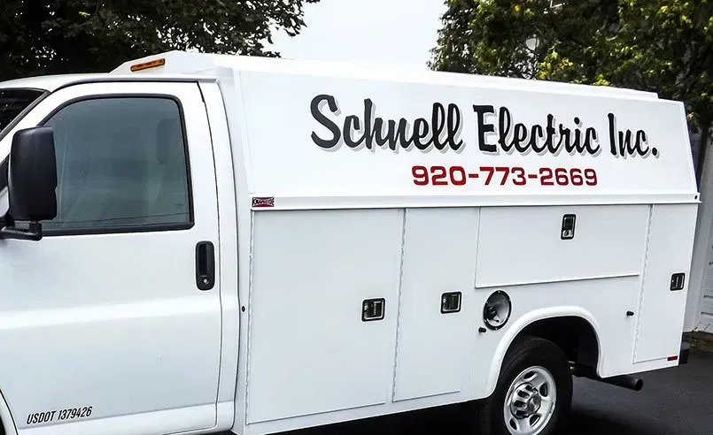 A white van for schnell electric inc. is parked on the side of the road