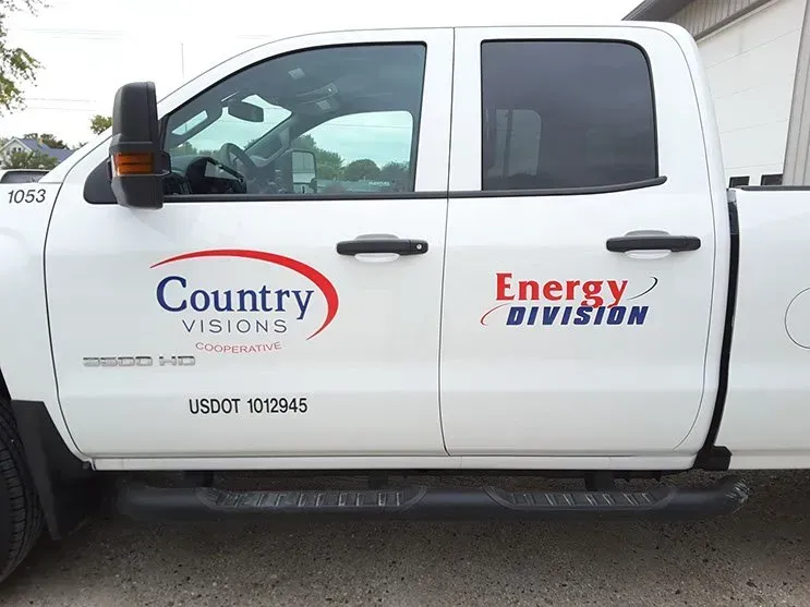 A white truck with the words country visions and energy division on the side