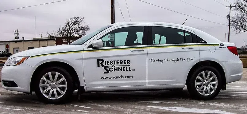 A white car with riesteren schnell written on the side
