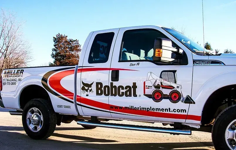 A white bobcat truck is parked in a parking lot