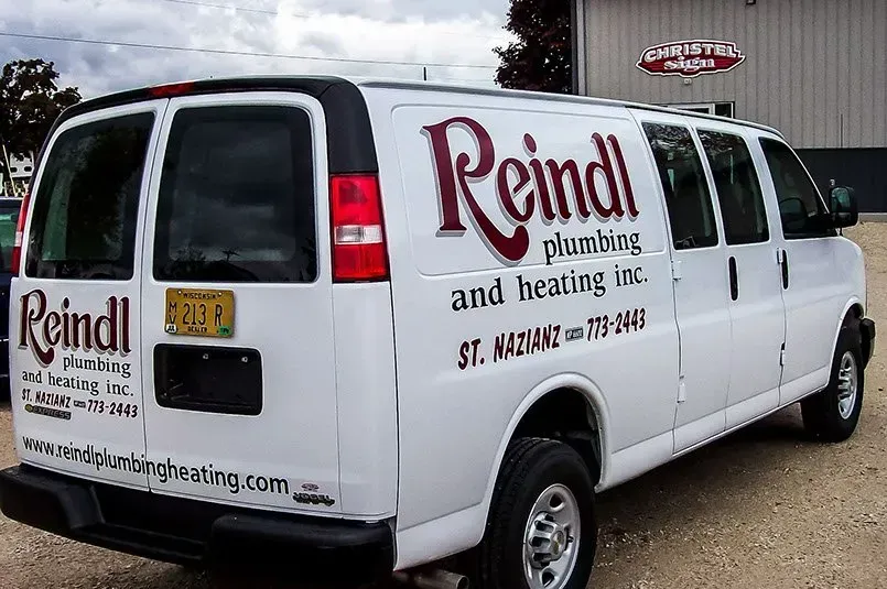 A white van with reindl plumbing and hearing written on it
