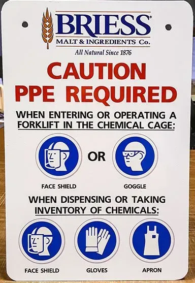 A sign that says caution ppe required when entering or operating a forklift in the chemical cage