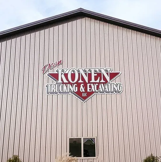 A building with a sign on it that says konen trucking and excavating