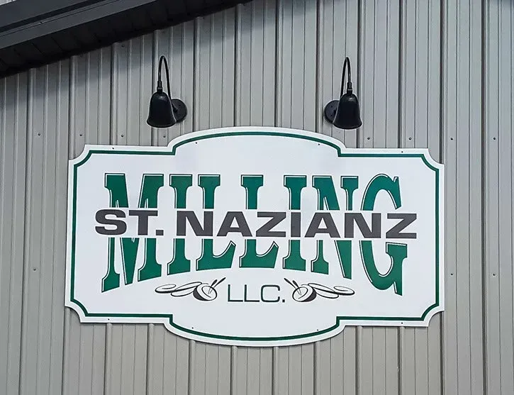 A sign on the side of a building that says milling st. nazianz milling llc