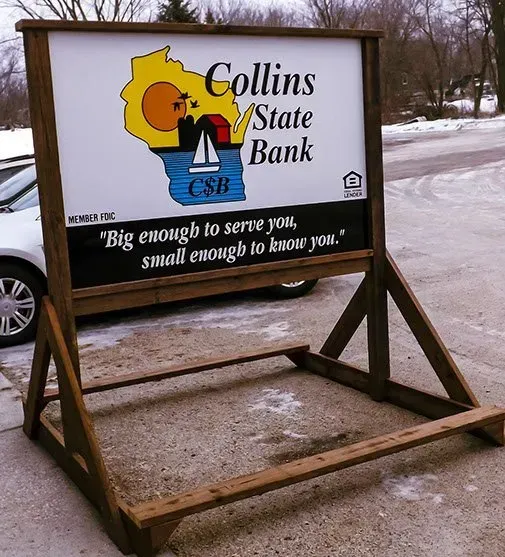A sign that says collins state bank on it