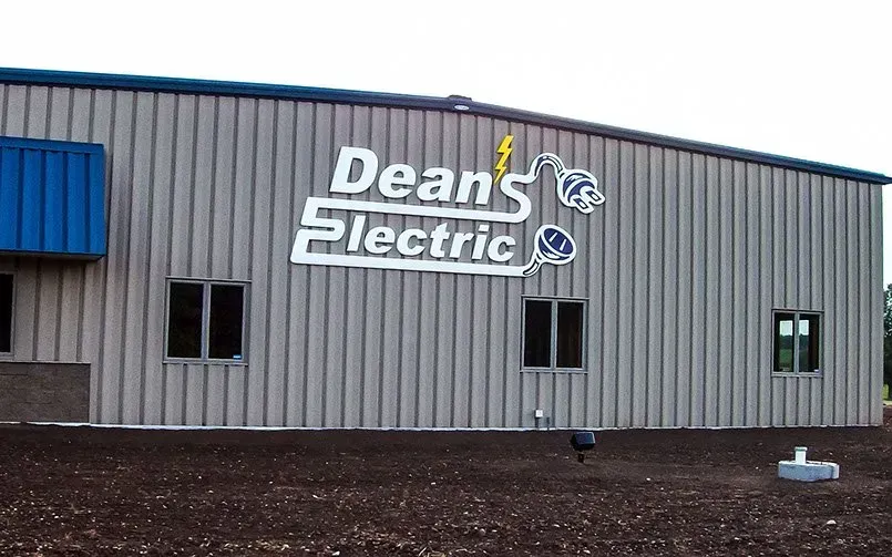 A building with a sign that says deans electric