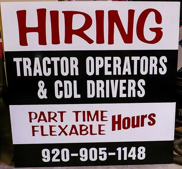 A sign that says hiring tractor operators and cdl drivers