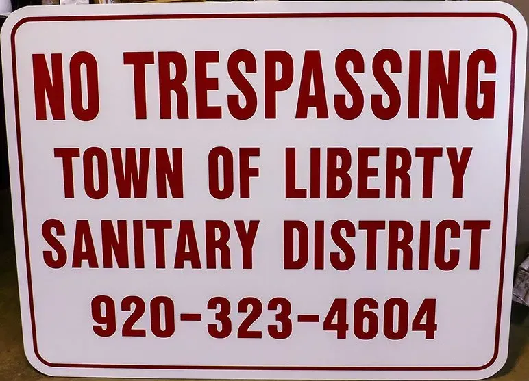 A sign that says no trespassing town of liberty sanitary district
