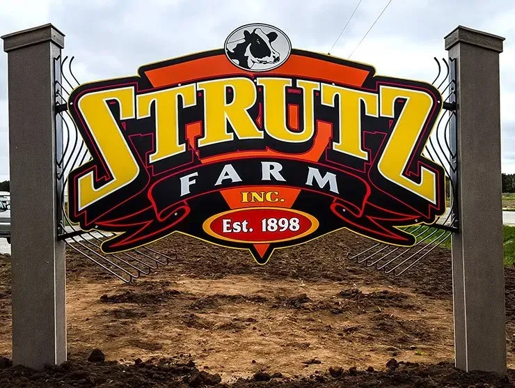 A sign that says strutz farm inc. on it