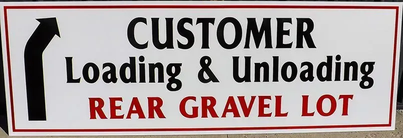 A sign that says customer loading and unloading rear gravel lot