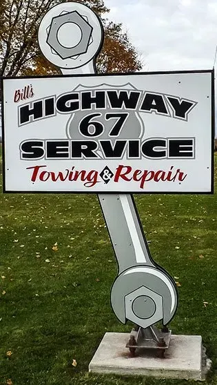 A sign for bill 's highway 67 service towing repair