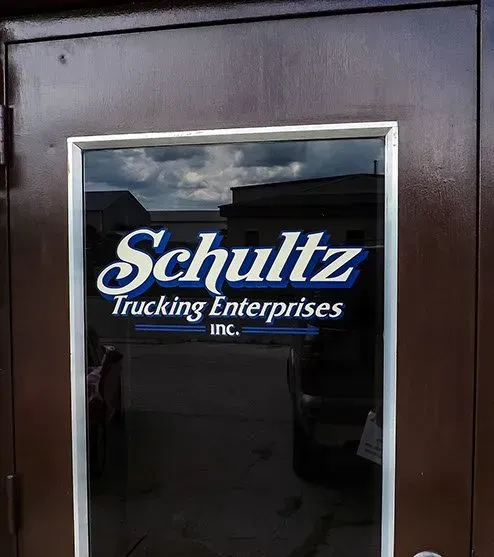 A door with a schultz trucking enterprises logo on it