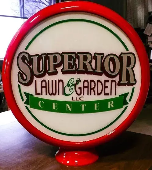 A superior lawn and garden center sign is sitting on a table