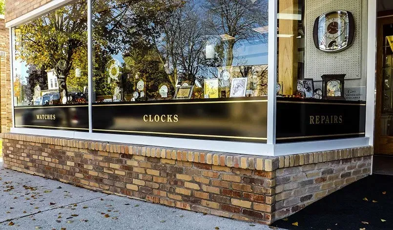 A store front with a window display of clocks.