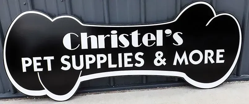A black and white sign for christel 's pet supplies and more