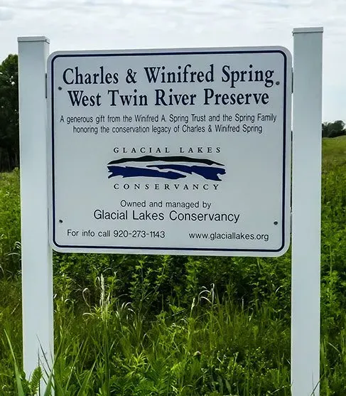 A sign that says charles & winifred spring west twin river preserve