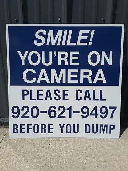 A sign that says smile you 're on camera