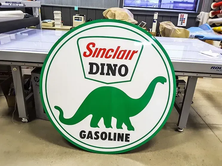 A sinclair dino gasoline sign is sitting on a table