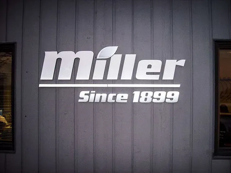 The miller since 1899 logo is on the side of a building.