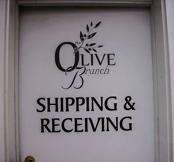 A sign for the olive branch shipping and receiving