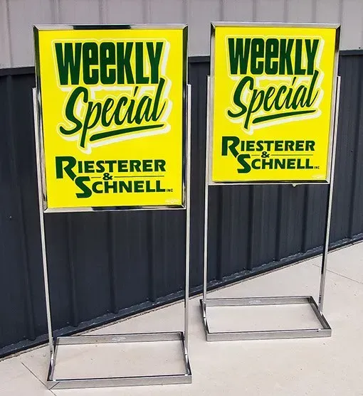 Two yellow signs that say weekly special on them