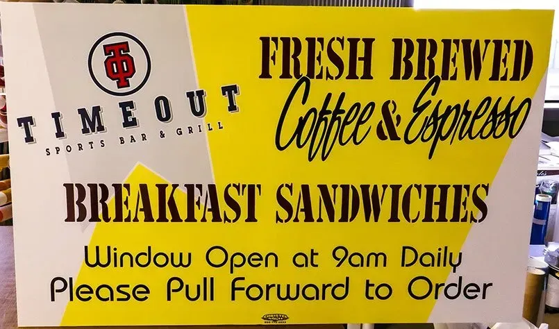 A sign for fresh brewed coffee and espresso breakfast sandwiches