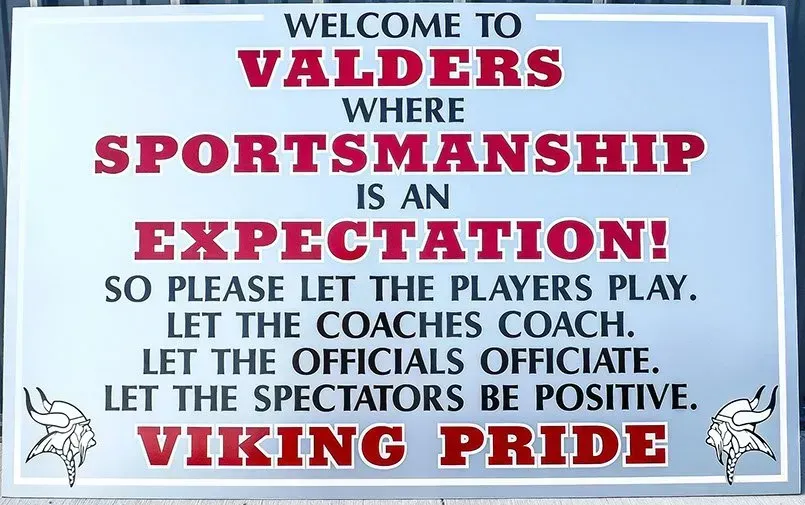 A white sign that says welcome to valders where sportsmanship is an expectation
