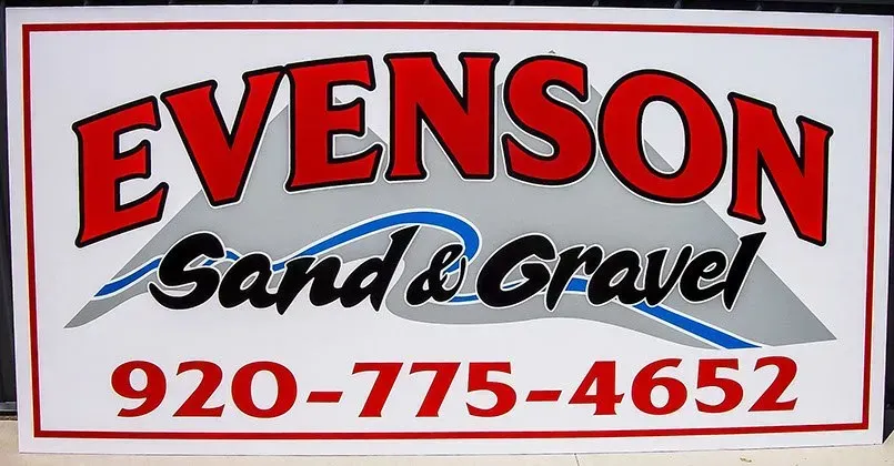 A sign for evenson sand and gravel with a phone number