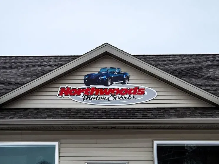 The roof of a house with a sign on it that says northwoods motor service.