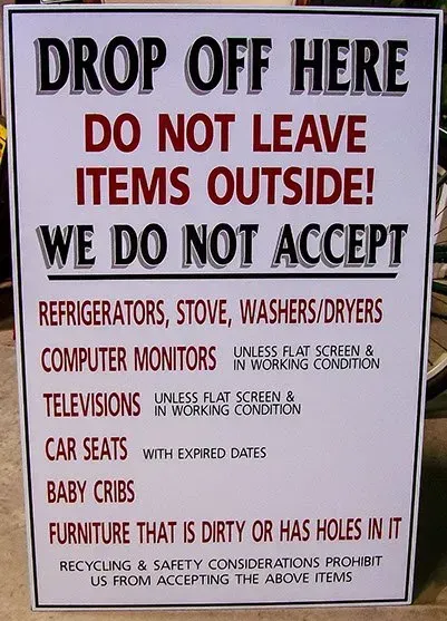A sign that says drop off here do not leave items outside we do not accept