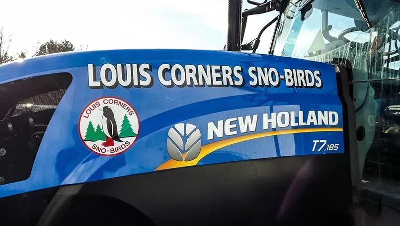A blue louis corners sno-birds new holland tractor