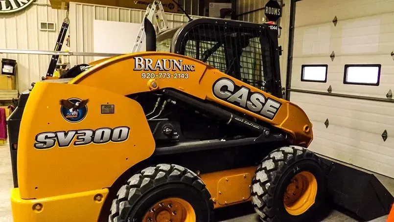 A case sv300 skid steer is parked in a garage
