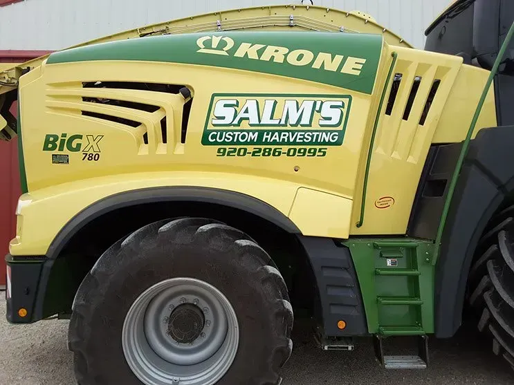 A yellow and green tractor with the word krone on it