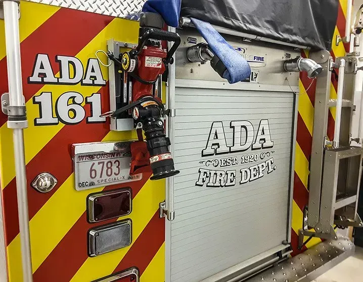 A yellow and red fire truck with the number 161 on it