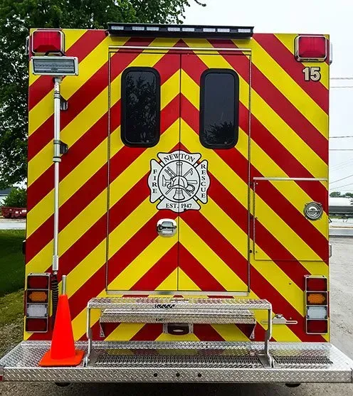 A red and yellow ambulance with the number 15 on the back