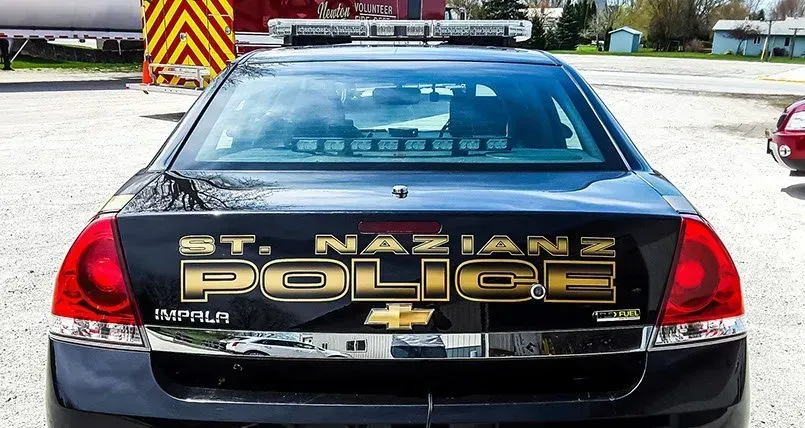 A st. nazians police car is parked in a parking lot