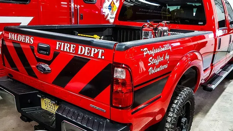 A red truck with the word fire dept on the back