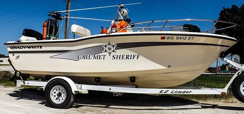 A boat on a trailer that says sheriff on it