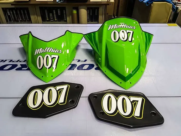 A green and black motorcycle with the number 007 on it