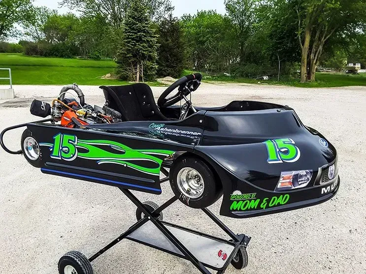 A black and green go kart with the number 15 on it